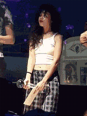 Me holding a microphone-shaped trophy and an envelope, with one middle finger subtly on display